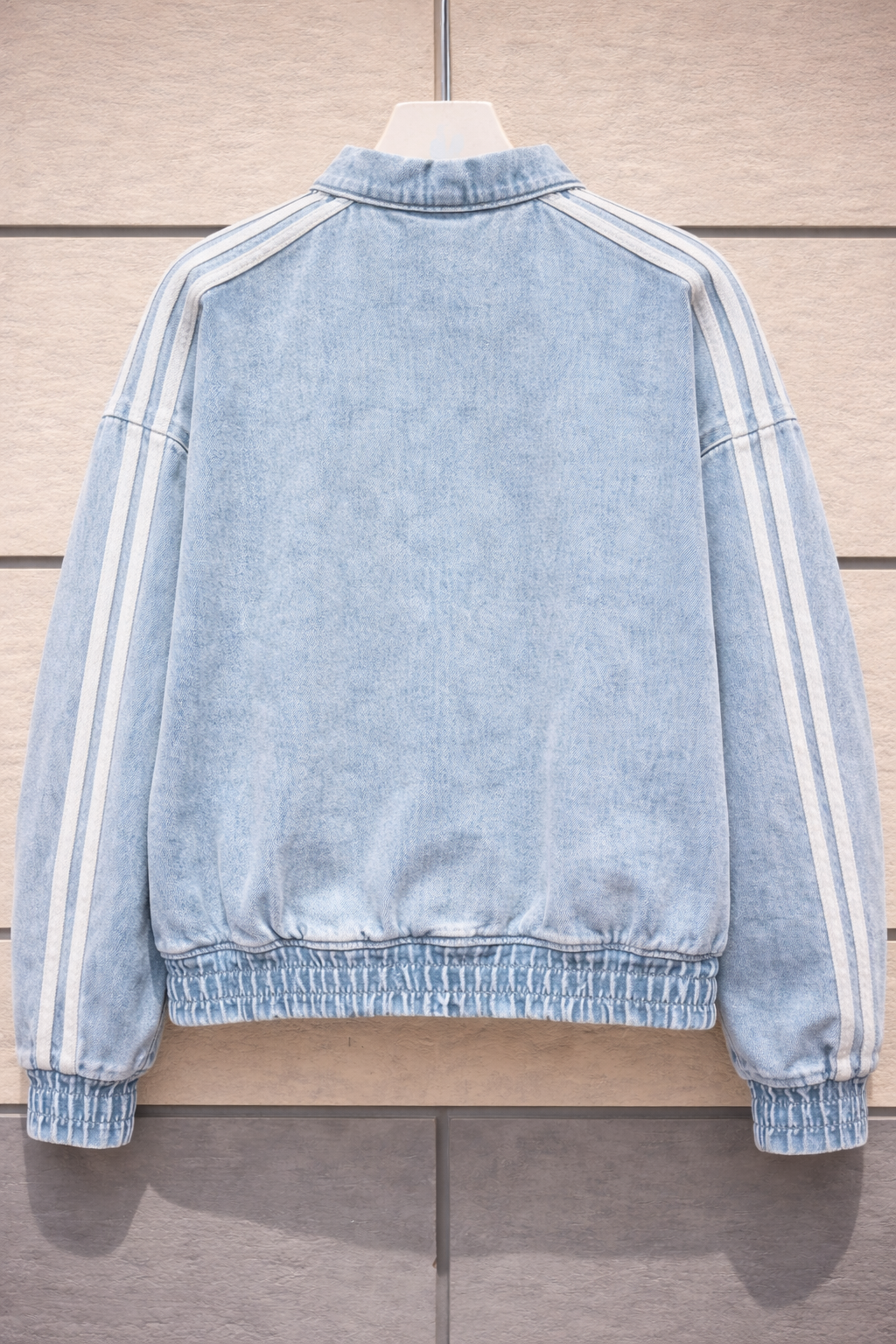 Back profile highlighting the festive streetwear aesthetic of the washed blue jacket.