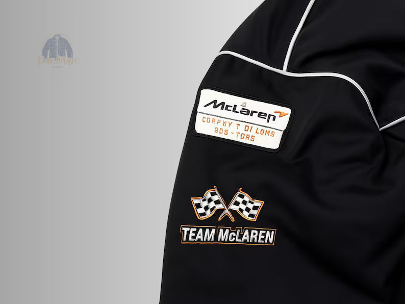 McLaren Formula 1 team patches against the stealth black background.