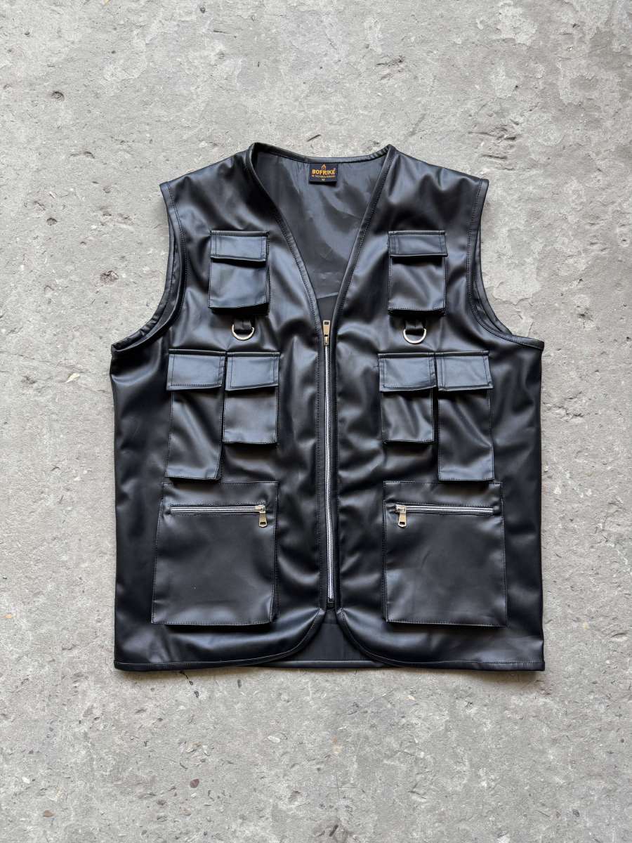 Model standing in the techwear vest black, wearing the ultimate black tactical vest for urban outfit.