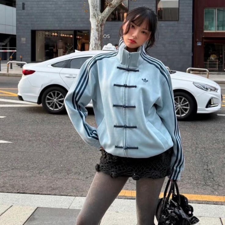 Model styling the oversized aqua blue jacket, the ultimate unisex Lunar New Year outfit women and men