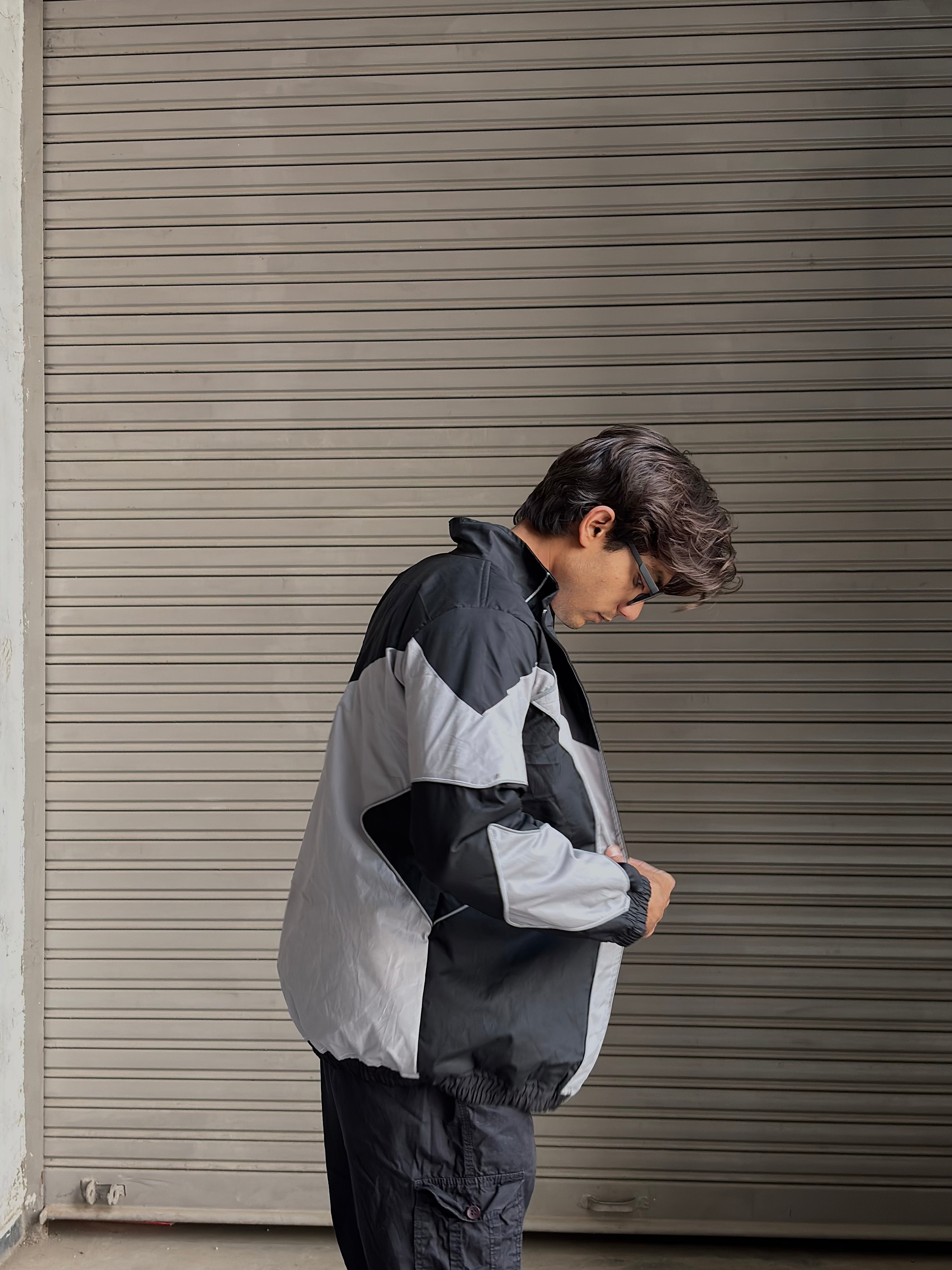 Model styling the breathable parachute jacket with baggy cargos and sneakers.