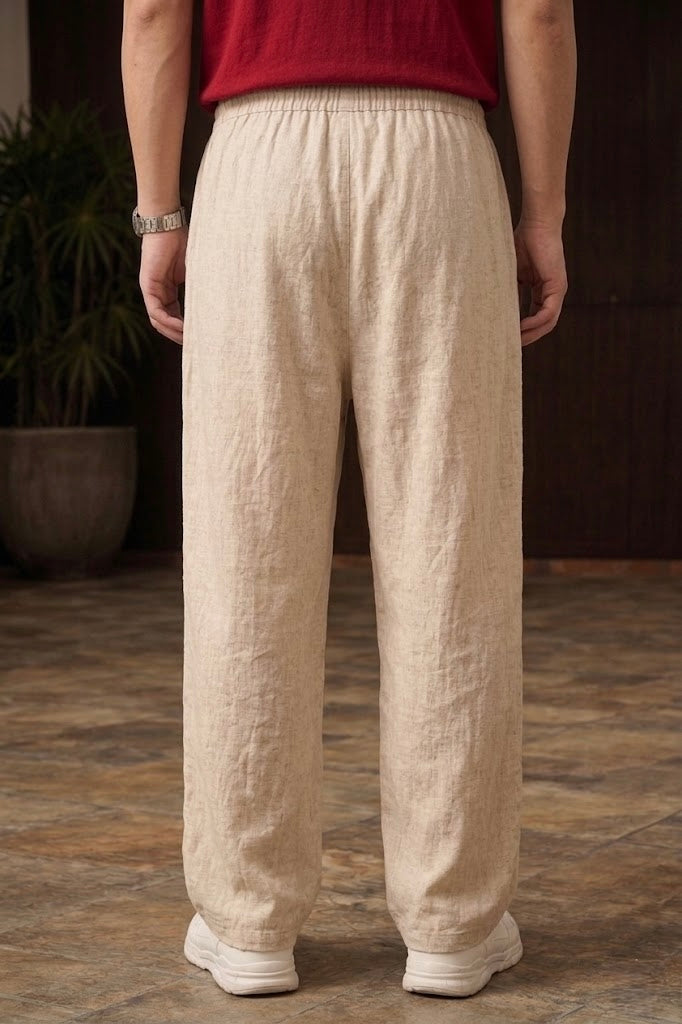Back angle of beige textured wide-leg casual pants showing the roomy fit and durable fabric opposite the side with the dragon embroidery.