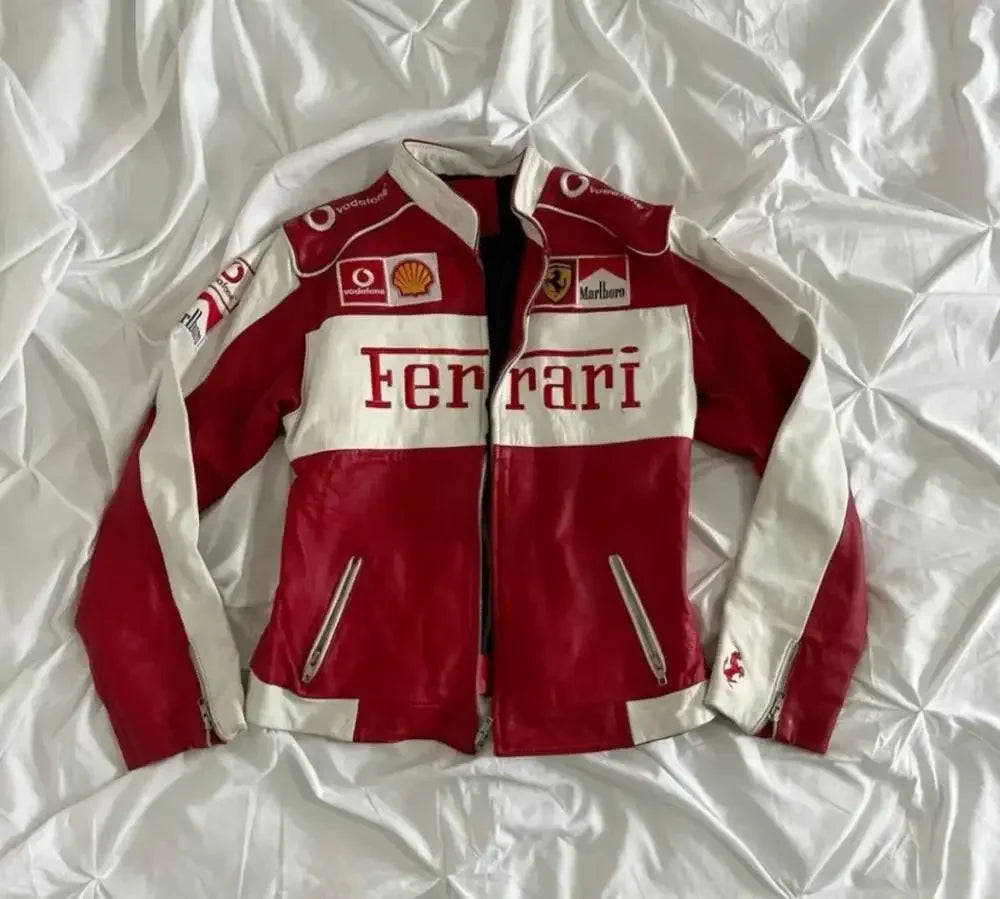 Red and white Ferrari leather jacket with racing patches, laid flat on a white surface